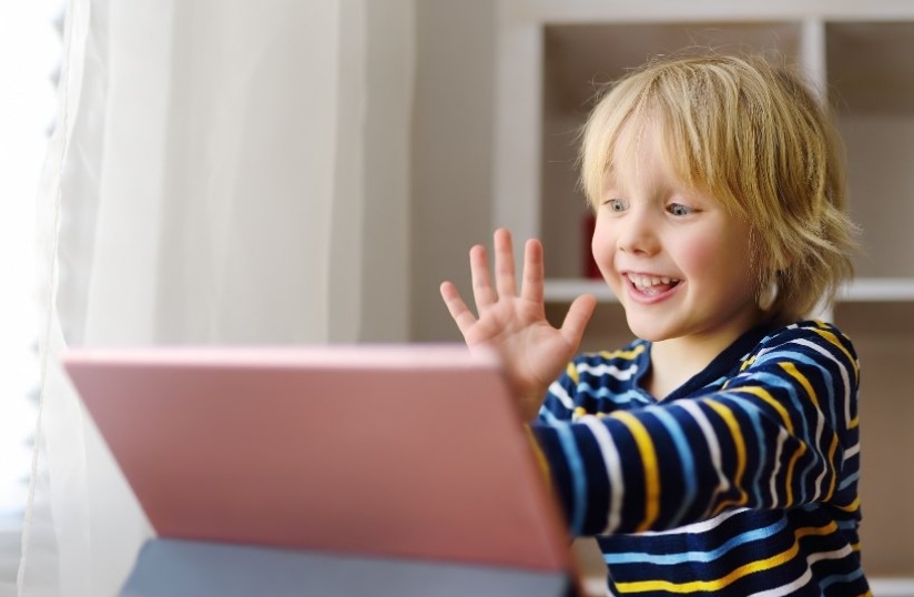 Grandchild on laptop having a conversation reflecting virtual grandparenting