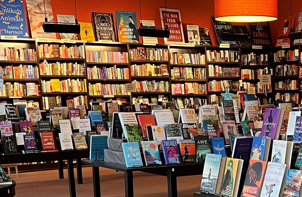 Interior of Flyleaf Bookstore, showing shelves filled with books and tables displaying various book selections