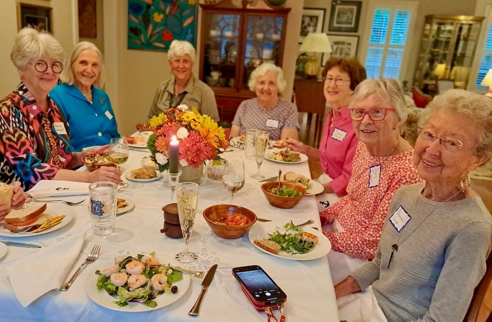 Group of women dining together at a senior living community, highlighting the health benefits and social connections in such environments.